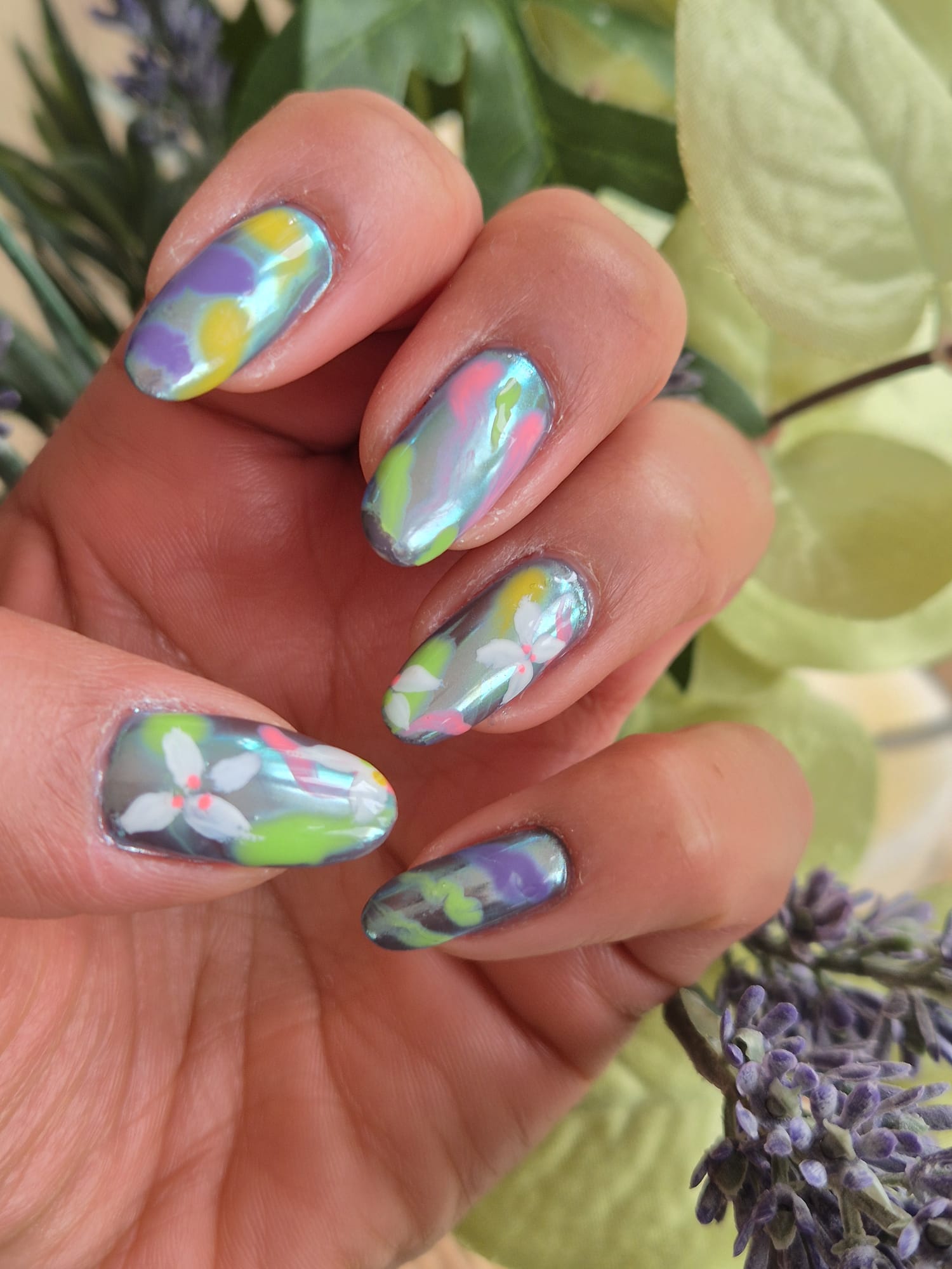 Chrome pastel abstract floral nails on lavender backdrop
