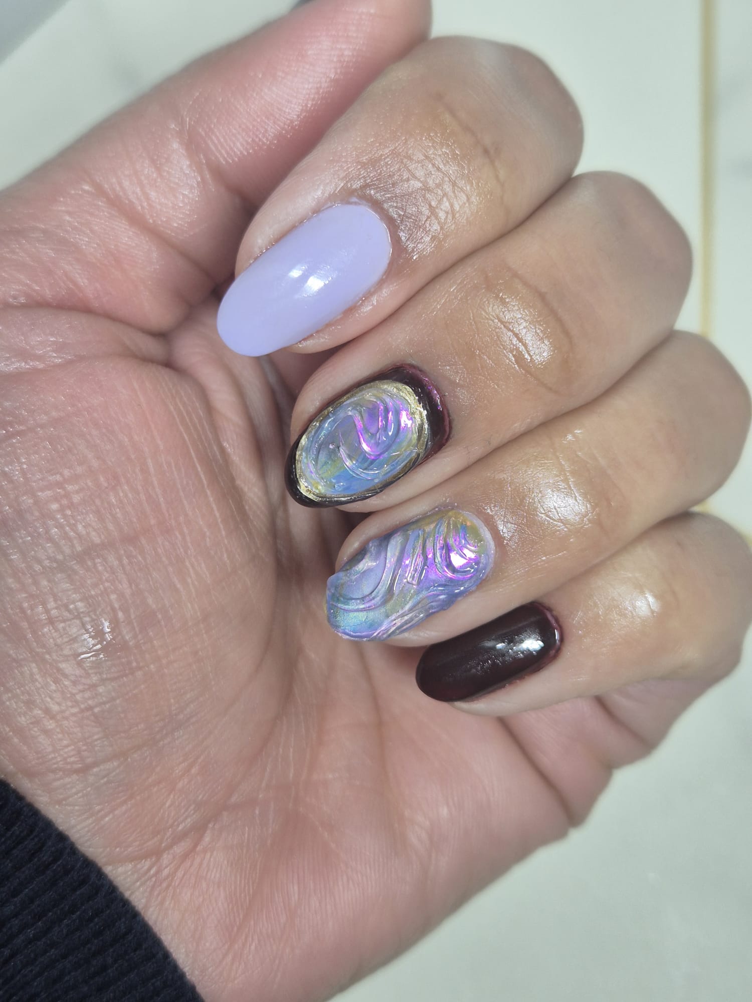 Lilac nails with iridescent 3D swirl and dark cherry accents