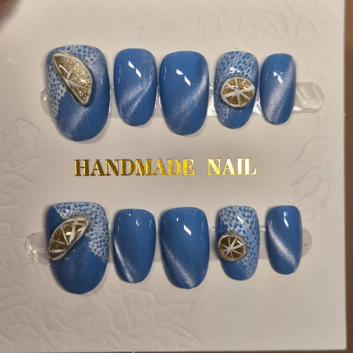 Blue cat-eye press-on set with 3D gilded citrus