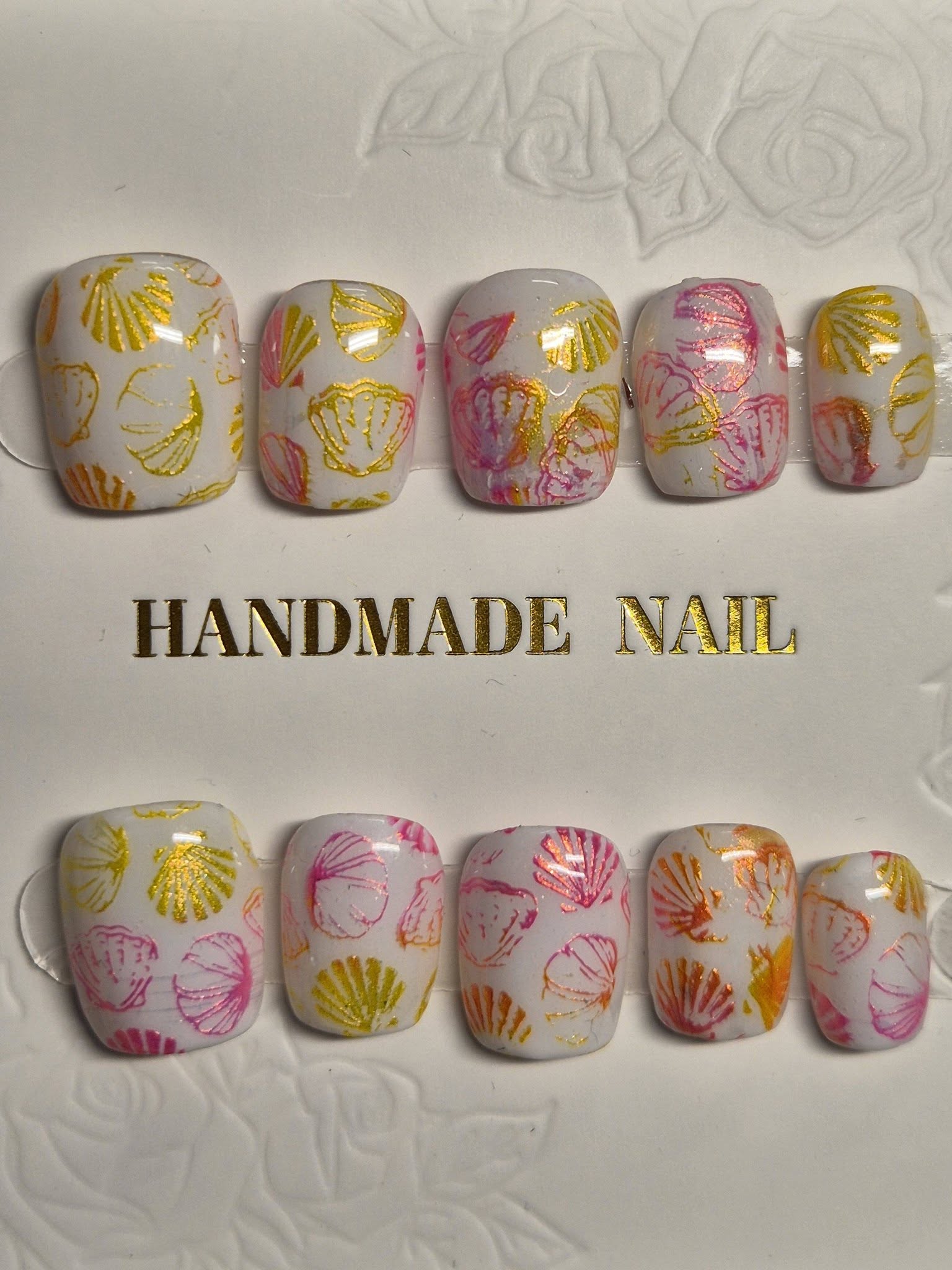 Press-on nail set with pastel seashell design